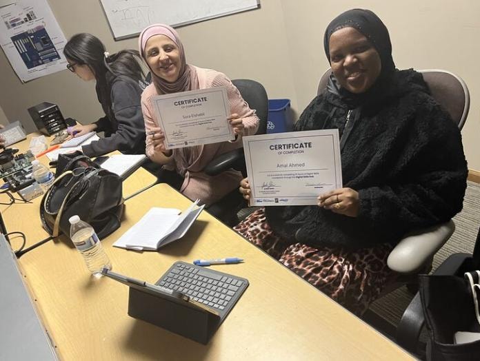 Students holding certificates of completion